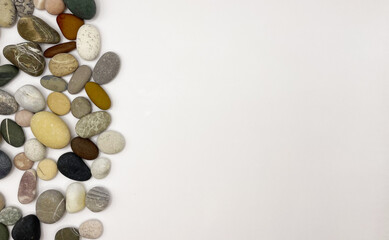 Sea stones on a white background. Lots of sea pebbles
