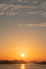 Orange sunset sun over the islands in the Mediterranean Sea