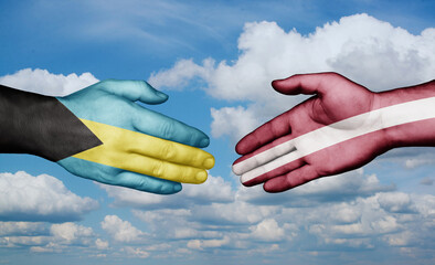 Latvia and Bahamas country handshaking with flags, consensus concept international co-operation illustration