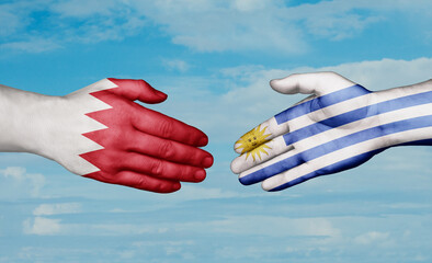 Uruguay and Bahrain country handshaking with flags, consensus concept international co-operation illustration