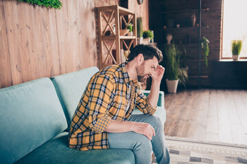 Photo of unhappy stressed guy dressed checkered shirt feeling bad staying home indoors house...