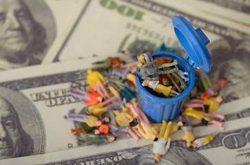 The image of businessmen slumped in a trash bin serves as a powerful metaphor for the collapse of unsustainable economic systems.