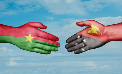 Papua New Guinea and Burkina Faso country handshaking with flags, consensus concept international co-operation illustration