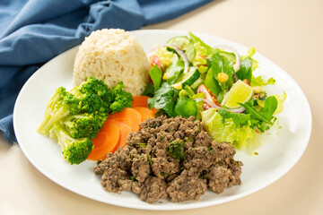 Healthy Plate with Ground Beef, Brown Rice, Vegetables, and Fresh Salad