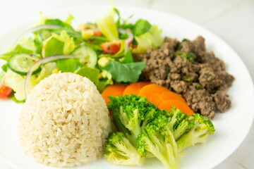 Healthy Plate with Ground Beef, Brown Rice, Vegetables, and Fresh Salad