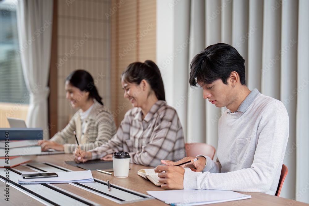Aufkleber group of focused student studying together in a modern classroom setting with laptops and notebooks