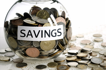 Conceptual artwork demonstrating the necessity of saving, with a glass jar filled with coins to signify an emergency fund