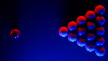 Top view shot of russian billiard green cloth table with white balls being hit by the red ball, person hitting the ball pyramid. Blue end red neon light.