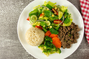 Healthy Plate with Ground Beef, Brown Rice, Vegetables, and Fresh Salad