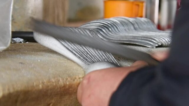 Ban Napia, Laos - 15th january, 2024: laotian people make aluminum spoons from Vietnam war era munition remains or UXO. Collect UXO , melt down in kiln and fashion it to spoons household items