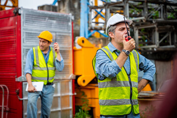 Three men in construction gear are talking to each other