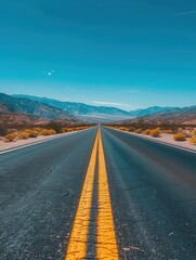 The empty asphalt road stretching through the desert, adventure awaits, clear blue sky, midday sun