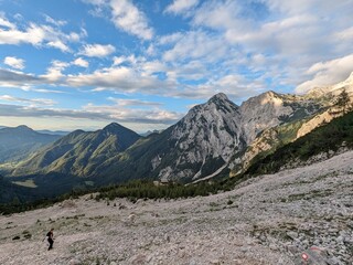 Panoramic view of the Slovenian Alps from a hiking trip and via ferrata to the top of Grintovec mountain on a hot summer day. Stunning alpine landscapes and challenging trails.

