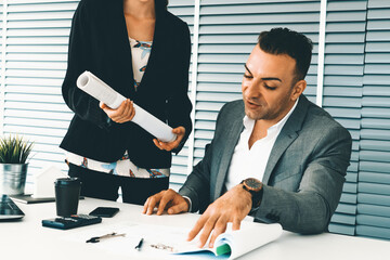 Businessman executive checking work while meeting discussion with businesswoman worker in modern workplace office. People corporate business team concept. uds