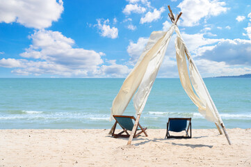 Relax time on the beach. beach chaise set up for travelers on the beach in Thailand with blue sky on sunny days. Summer vacation and holiday.