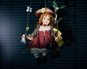 Doll on swing on