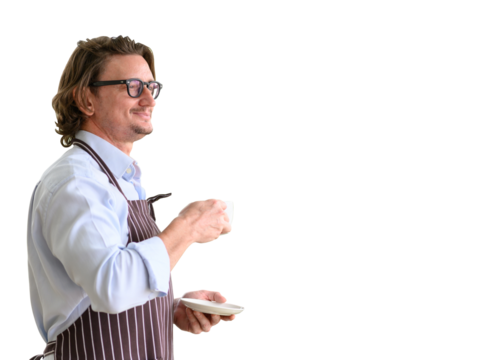 Portrait of happy senior man wearing glasses and denim apron spending and holding cup of hot coffee enjoying isolated on white background. - Powered by Adobe