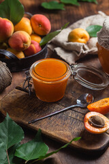 Ripe apricot jam in a jar on the table