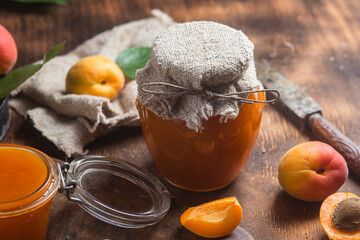 Ripe apricot jam in a jar on the table