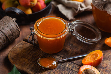 Ripe apricot jam in a jar on the table