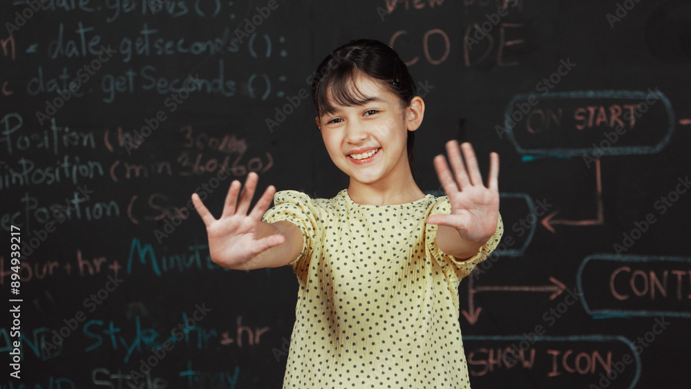 Poster cute happy girl waving to camera while standing at blackboard with engineering prompt or coding, pro