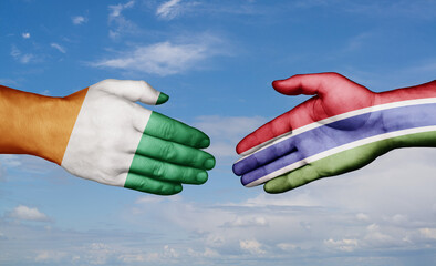 Gambia and Ivory Coast country handshaking with flags, consensus concept international co-operation illustration