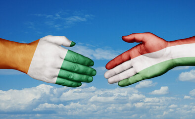 Hungary and Ivory Coast country handshaking with flags, consensus concept international co-operation illustration