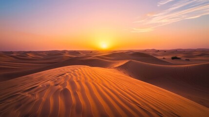 Dubai desert at dawn, when the first light of day casts long shadows across the undulating sands.