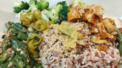 mixed vegetarian cuisine with brown rice and green chilies