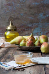 Front view elegant vintage table presentation of traditional Turkish compote/ komposto or hosaf with pears on hand embroidered antique napkins