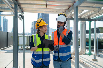 Engineer under checking the industry chilled water fan coil unit air conditioner is water cooling tower air chiller HVAC system of large industrial building to control air system