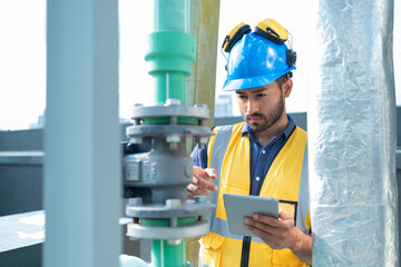 Technician Operating Control Panel in Industrial Setting