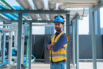 Engineer Inspecting Industrial Pipes on Rooftop