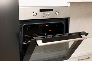 Obraz premium Open electric oven in kitchen. Cooking appliance