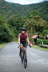 Fototapeta premium a young woman riding her gravel bike in the mountains.