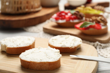 Delicious bruschettas with ricotta cheese on table, closeup