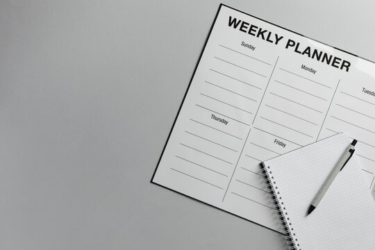Timetable. Planner, notebook and pen on grey table, top view. Space for text