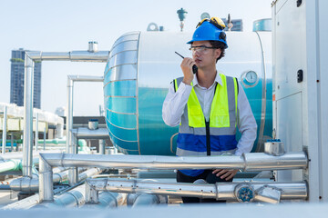Engineer under industrial inspection Large water heaters are used in high-rise condominiums.