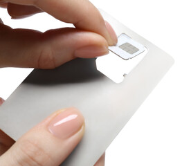 Woman removing SIM card from holder on white background, closeup