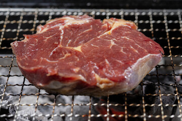 Raw Steak on Barbecue Grill Grate