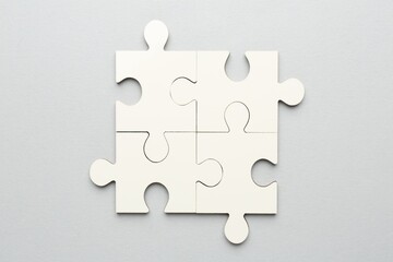 White puzzle pieces on grey background, top view