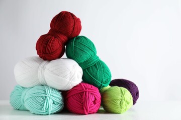 Many soft skeins of yarn on light grey background