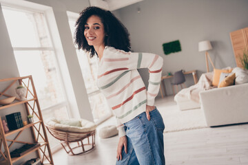 Photo of shiny good mood lady dressed striped pullover smiling indoors apartment room