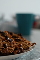 A close-up view of a plate filled with homemade oatmeal cookies, highlighting their texture and wholesome ingredients