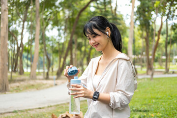 Young woman holding water bottle to drink.