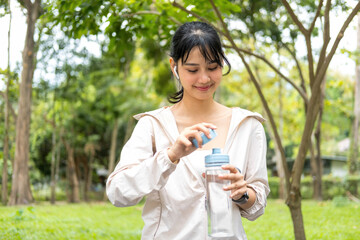 Young woman holding water bottle to drink.