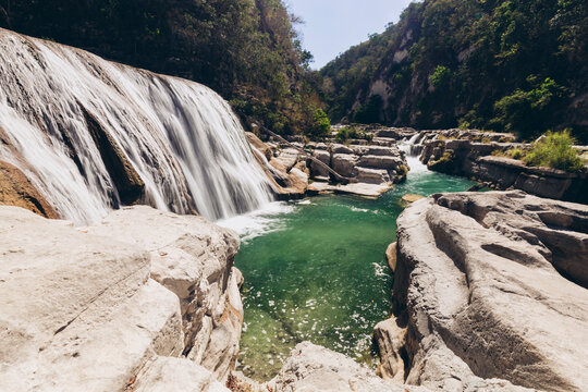 Beautiful waterfalls and cascades through a rocky landscape at Air Terjun Tanggedu, Indonesia; Ndapayami, Kanatang, East Sumba Regency, East Nusa Tenggara, Indonesia