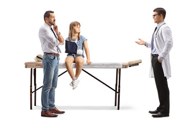 Obraz premium Father and kid with a broken arm at a hospital talking to a doctor