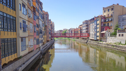 Naklejka premium Girona, Spain - 23 July, 2024: Colored houses on River Onyar, Girona, Catalonia