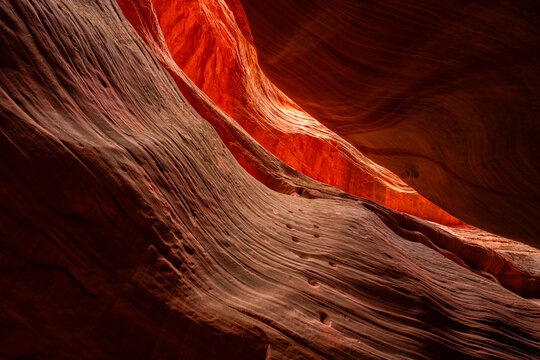 Sunlight illuminates the red striations of Mystic Canyon, an amazing place to walk through and explore. Eons of erosion have created amazing feats of nature; Kanab, Utah, United States of America